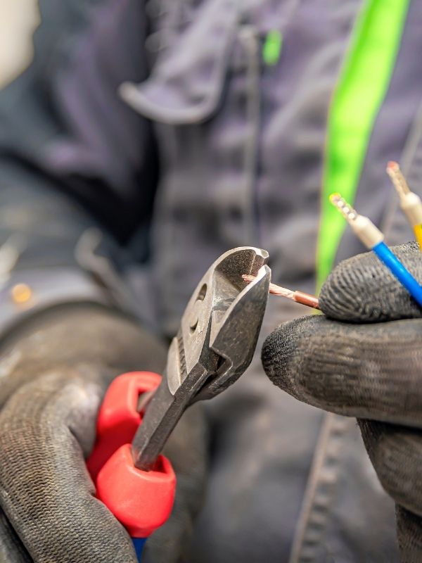 An electrician working on electrical wires. 