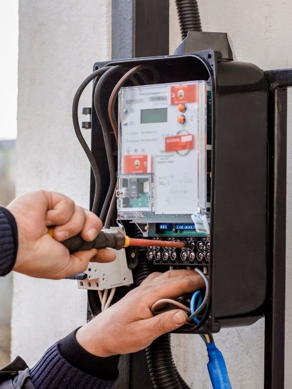A commercial electrician working on an electrical system. 