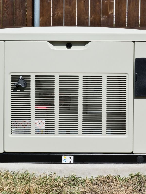 A Generac generator in the backyard of a residential property. 