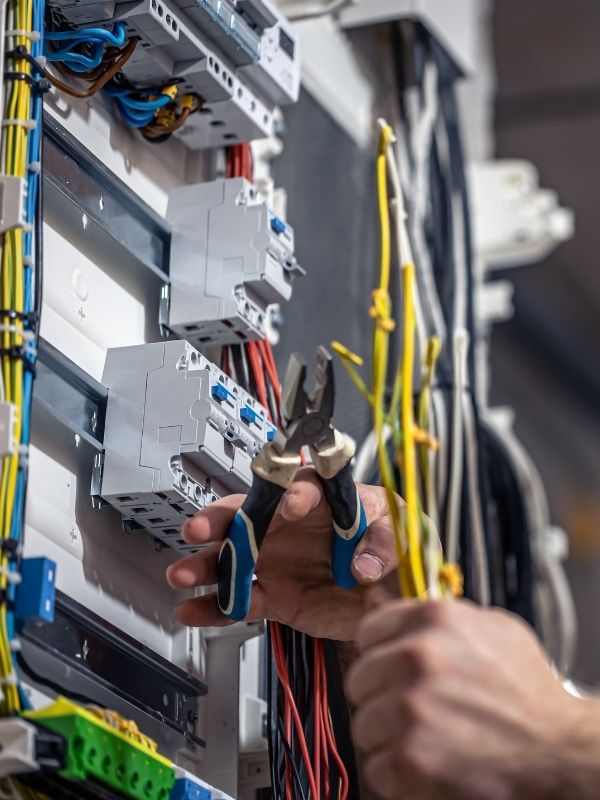 An electrician is working on a breaker panel for an industrial plant. 