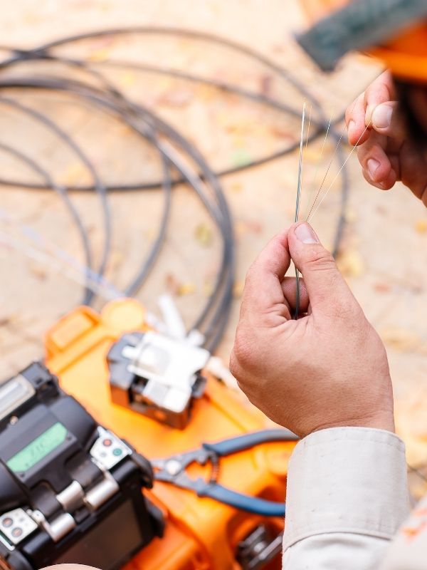 A technician working on setting up wires. 