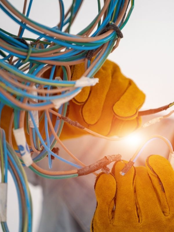 A technician working on wires for an office. 